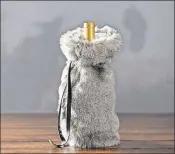  ?? POTTERY BARN ?? Present your host with a bottle of wine covered in a faux fur.