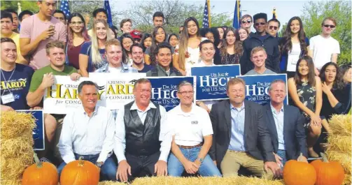  ??  ?? LAS VEGAS: Mitt Romney, Rep. Cresent Hardy, Rep. Joe Heck, Sen. Dean Heller and Nevada Lt. Gov. Mark Hutchison pose for photos with campaign volunteers at a campaignra­lly on Saturday.—AP