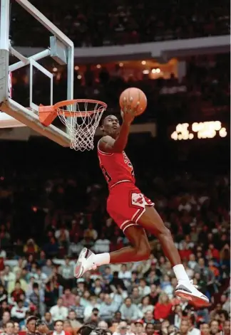  ?? AP Photo ?? BLAST FROM THE PAST. In this Feb. 6, 1988, file photo, Chicago Bulls’ Michael Jordan dunks during the slam-dunk competitio­n of the NBA All-Star weekend in Chicago. Jordan left the old Chicago Stadium that night with the trophy. To this day, many believe Wilkins was the rightful winner.