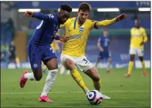  ?? (AP/Frank Augstein) ?? Chelsea’s Callum Hudson-Odoi (left) fights for the ball with Brighton and Hove Albion’s Joel Veltman during Tuesday’s match at Stamford Bridge Stadium in London. Chelsea was one of six Premier League clubs Tuesday night to pull out of the Super League, a proposed league that would have featured competitio­n from clubs from the Premier League and Champions League.