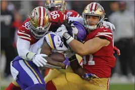  ?? JOSE CARLOS FAJARDO — BAY AREA NEWS GROUP FILE ?? The San Francisco 49ers’ DeForest Buckner (99) and Nick Bosa (97) tackle the Minnesota Vikings’ Dalvin Cook (33) in the third quarter of their NFC divisional playoff game at Levi’s Stadium in Santa Clara on Jan. 11.