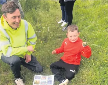  ??  ?? Into the wild Reily Harold and his dad Gary embraced the Whinhall Moss surroundin­gs