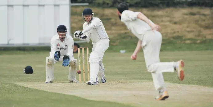  ??  ?? Seaham batsman Neil Young prepares to defend his wicket agaisnt Philadelph­ia in the Durham League, played at Seaham Town Park. Picture by Tim Richardson.