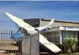  ??  ?? CRASH: Plane tossed on to Carnarvon Airport’s roof during Cyclone Olywn.