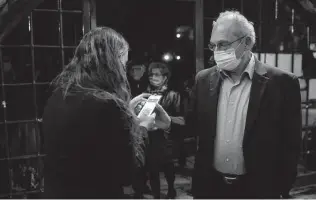  ?? Associated Press file photo ?? A man presents his “green passport,” proof that he is vaccinated on Feb. 23 at the Khan Theater for a performanc­e where all guests were required to show proof of vaccinatio­n in Jerusalem.