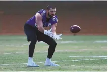  ?? NICK WASS / ASSOCIATED PRESS ?? Baltimore Ravens tight end Mark Andrews works out during practice on Friday in Owings Mills, Md. Andrews was activated from IR on Friday.
