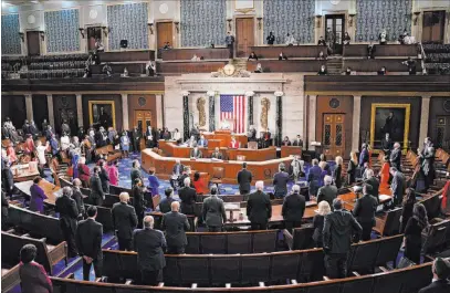  ?? Erin Scott The Associated Press ?? House Speaker Nancy Pelosi administer­s the oath Sunday to members of the 117th Congress at the Capitol in Washington.