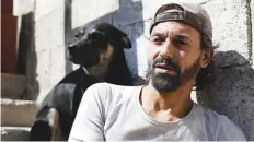  ?? Reuters ?? Abu Nimr is shown with his dog Balo in Yarmouk district of Damascus last week.