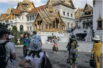  ?? AFP FILE PHOTO ?? Tourists gather and take pictures in the grounds of the Grand Palace in Thailand’s capital Bangkok on July 18, 2022.