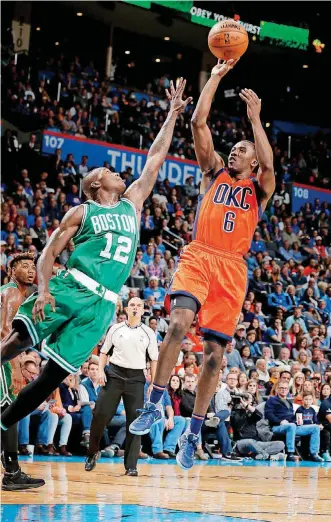  ?? [PHOTO BY SARAH PHIPPS, THE OKLAHOMAN] ?? Oklahoma City’s Semaj Christon, right, shoots as Boston’s Terry Rozier defends during Sunday’s NBA game at Chesapeake Energy Arena.