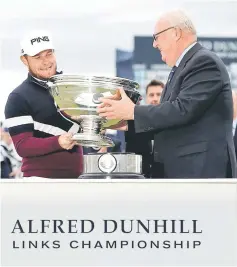  ??  ?? England’s Tyrrell Hatton celebrates winning the Alfred Dunhill Links Championsh­ip with the trophy. — Reuters photo