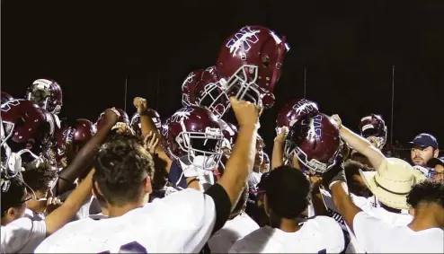  ?? Sean Patrick Bowley / Hearst Connecticu­t Media ?? Windham football players celebrate a 56-14 victory over E.O. Smith in Storrs back in September.