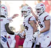  ?? NWA Democrat-Gazette/CHARLIE KAIJO ?? UA tight end Austin Cantrell (center) celebrates with teammates after scoring a touchdown late in Saturday’s win at Reynolds Razorback Stadium.