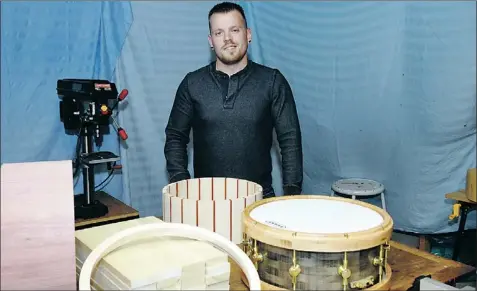  ?? — Photo by Tobias Romaniuk/the Telegram ?? Stephen Little, of Stephen Little Handcrafte­d Drums, poses with drums in various stages of constructi­on at his home workshop.