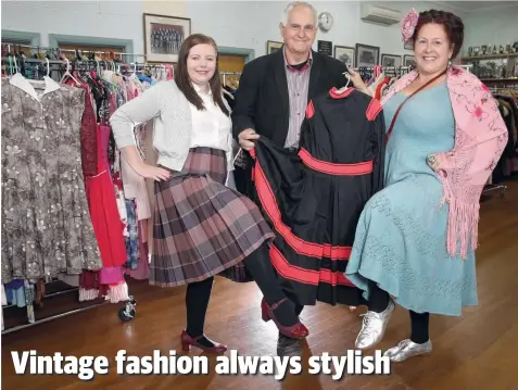  ?? Picture: MIKE DUGDALE ?? FROCK STARS: Organiser Keith Baverstock holding reproducti­on 1850s swimsuit, with Kira Nieuwenhui­s, of Leopold (left), and Catherine Fraser, who was selling vintage clothing at the event.
