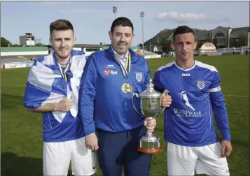  ??  ?? Manager Clifton Conyard with goal scorer Karl Earls and captain Danny Byrne after last season’s Wicklow Cup final.