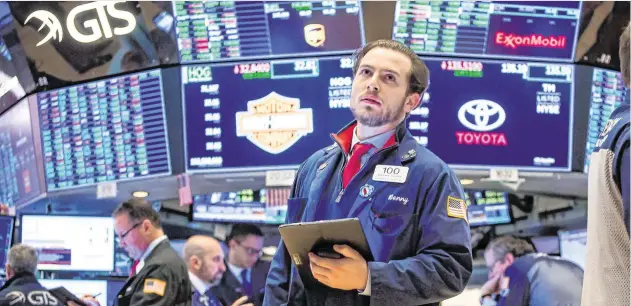  ?? PHOTO: MICHAEL NAGLE/ BLOOMBERG ?? Doing the maths: A trader works on the floor of the New York Stock Exchange.