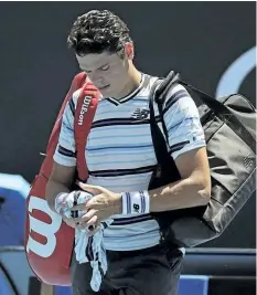  ?? DITA ALANGKARA/THE ASSOCIATED PRESS ?? Canada’s Milos Raonic leaves the court following his first round loss to Slovakia’s Lukas Lacko at the Australian Open on Tuesday.