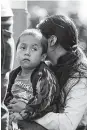  ?? Gregory Bull / Associated Press ?? A woman and her son wait to apply for asylum at the U.S. border in Tijuana, Mexico.