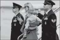  ?? AP/EVAN VUCCI ?? Carrying her son Theodore Kushner, Ivanka Trump arrives Jan. 19 at Andrews Air Force Base, Md., for her father’s inaugurati­on. Her longtime acquaintan­ce Phillip Bloch said afterward, “You could just tell she was coming to Washington to make her mark.”