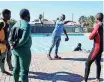  ?? | BRENDAN MAGAAR African News Agency (ANA) ?? SENIOR beach lifeguard Mzikayise Jacobs showing Langa community members the ropes on swimming.