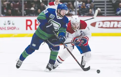  ?? RICH LAM/GETTY IMAGES ?? Quinn Hughes of the Canucks is held back from the puck by Montreal’s Brendan Gallagher at Rogers Arena on Tuesday. Undersized when drafted by the Giants in 2007, Gallagher soon blossomed and any Canadiens highlight package these days will likely include him.