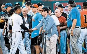  ?? BRENDAN SMIALOWSKI/GETTY-AFP ?? Rep. Cedric Richmond, D.-La., left, greets congressio­nal staffer Zack Barth, who was wounded inWednesda­y’s shooting.