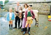  ??  ?? Vet in harness: Alf Wight – aka the real James Herriot – on his farm in 1995, top; Christophe­r Timothy and Lynda Bellingham (preceded by Carol Drinkwater) starred as James and his wife in the BBC series, pictured above in 1998 with Rebecca Smith and Oliver Wilson as their children