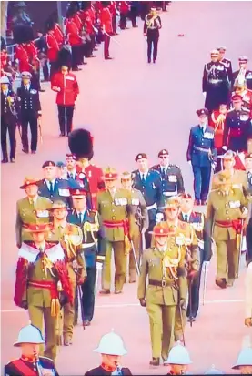  ?? ?? Colonel Paul Curry (army uniform on right) marches The Mall in the Queen’s funeral procession.