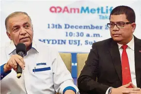  ??  ?? Smart partnershi­p: Ameer (left) and Noor Azam at the launch of the iMeriah Takaful. AmMetLife Takaful and Mydin has teamed up to offer iMeriah for eligible Mydin Meriah card members nationwide.