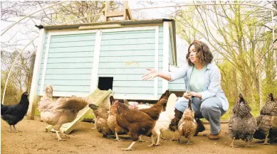  ?? PAUL W. GILLESPIE/CAPITAL GAZETTE PHOTOS ?? Bridget Jones feeds chickens Saturday at Wildberry Farm in Crownsvill­e. Jones and her husband, Matt, have adapted their business to accommodat­e the changing climate due to COVID-19.