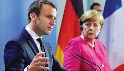  ?? JOHN MACDOUGALL |AFP ?? Presidente francês Emmanuel Macron incentiva chanceler alemã Angela Merkel a desenhar a estratégia para tornar a União apetecível