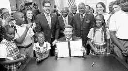  ?? COURTESY OF THE GOVERNOR'S OFFICE ?? Gov. Ron DeSantis in 2019 signing Florida’s fifth voucher program into law at a South Florida private school.