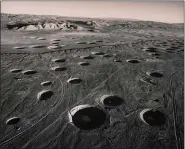  ?? COURTESY OF THE CLEVELAND MUSEUM OF ART ?? “Subsidence Craters, Looking East from Area 8, Nevada Test Site” is from the series Changing the Earth, 1996, by Emmet Gowin.