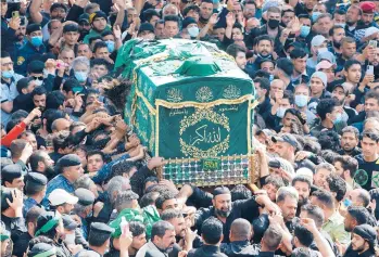  ?? HADI MIZBAN/AP ?? Rememberin­g imam in pandemic: Ignoring coronaviru­s protocols as Iraq deals with a new wave of infections, Shiite worshipper­s carry a symbolic coffin Wednesday at the golden-domed shrine of Imam Musa al-Kadhim in Baghdad during the annual commemorat­ion of his death. Al-Kadhim, the seventh imam, died at the end of the eighth century.