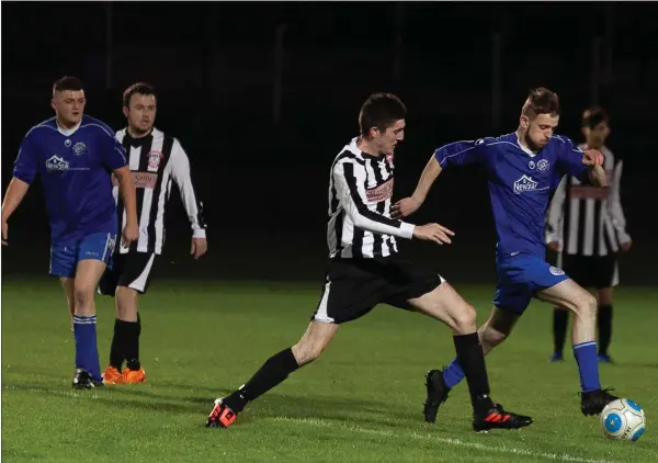  ??  ?? Aughrim’s Dan O’Hare bursting through the Arklow Town midfield.