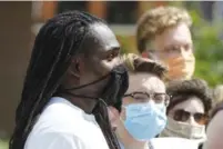  ?? STAFF PHOTO BY C.B. SCHMELTER ?? A protester this past weekend wears the kind of face mask distribute­d by the state. Distributi­on of the masks has now halted as a result of a chemical additive.