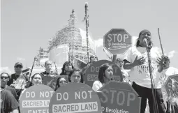  ?? MOLLY RILEY/AP 2015 ?? Councilman Wendsler Nosie speaks with activists from the Apache Tribe in a rally to save sacred land known as Oak Flat near Superior, Arizona.