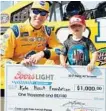  ?? CHRIS TROTMAN/GETTY IMAGES ?? Kyle Busch and son Brexton pose with the award after qualifying for the pole position for Sunday’s race.