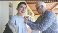  ??  ?? Joey Travolta signs the shirt of D’Angelo Hernandez, 14, during his film camp at Lincoln Tech Academy in Lodi on Thursday.