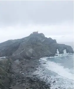  ??  ?? Fog engulfs San Juan de Gaztelugat­xe, the setting for Dragonston­e in the HBO hit series Game of Thrones, which begins its final season on Sunday.