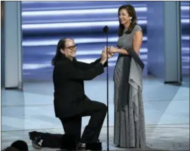  ?? PHOTO BY CHRIS PIZZELLO — INVISION — AP ?? Glenn Weiss , left, proposes to Jan Svendsen at the 70th Primetime Emmy Awards on Monday, Sept. 17, at the Microsoft Theater in Los Angeles.