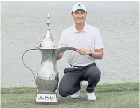  ??  ?? Li Haotong of China poses with the Dubai Desert Classic trophy.