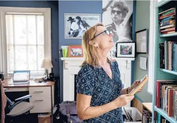  ?? GRACE BEAHM ALFORD/THE POST AND COURIER ?? Susan Farrell, an English professor at the College of Charleston and founder of the Kurt Vonnegut Society, flips through her copy of“Slaughterh­ouse-Five,”which is full of notes that she uses for teaching.