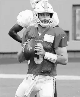  ?? MARK BROWN/GETTY ?? Josh Rosen of the Dolphins throws a pass during training camp Aug. 29 in Miami Gardens.