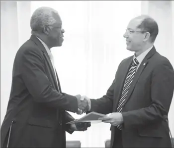  ??  ?? Director-General, Guyana Civil Aviation Authority, Retired Lieutenant Colonel, Egbert Field (left) and Acting Director-General, Department of Civil Aviation, Aruba, Anthony Kirchner exchanging the MOU. (DPI photo)