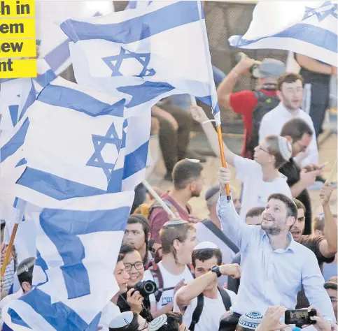  ?? Picture: AP Photo/Mahmoud Illean ?? Israeli Knesset member Bezalel Smotrich, centre, waves an Israeli flag together with other Jewish ultranatio­nalists during the “Flags March” next to Damascus gate, outside Jerusalem’s Old City on Tuesday.