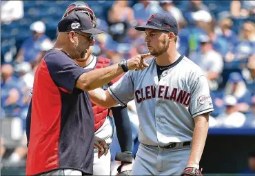 ?? ED ZURGA / GETTY IMAGES ?? As Indians manager Terry Francona reached the mound, he and pitcher Trevor Bauer appeared to exchange words. Francona pointed Bauer toward the dugout, then followed closely behind him.