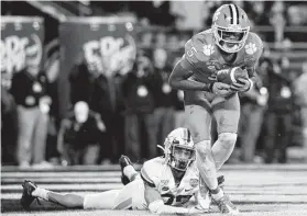  ?? Streeter Lecka / Getty Images ?? Clemson’s Tee Higgins (5) catches a touchdown pass during the ACC championsh­ip game. He finished with three TD catches and 182 receiving yards.