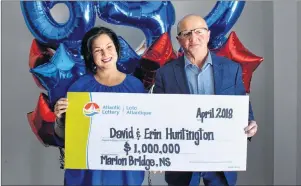  ?? DAVID JALA/CAPE BRETON POST ?? Erin and David Huntington pose with an oversized Atlantic Lottery cheque for $1 million. The Marion Bridge couple claimed the prize during an official ceremony on Tuesday at the Membertou Trade and Convention Centre after their ticket number matched...